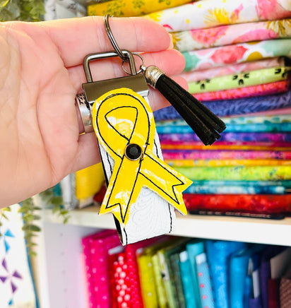 Awareness Ribbon Wristlet Keychain - yellow on white textured strap with black stitching and black tassel 